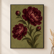 Framed canvas wall art depicting full burgundy peony blooms with buds and leaves against an olive green ground on a neutral wall