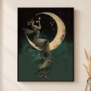 Framed canvas wall art depicting a floating woman seated on a glowing crescent moon in a starry dark sky on a neutral wall