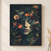 Framed canvas wall art depicting a woman's face surrounded by vivid flowers and butterflies on a dark ground on a neutral wall