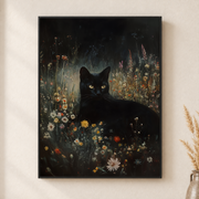 Framed canvas wall art depicting a black cat sitting among tiny yellow and white wildflowers at night on a neutral wall