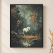 Framed canvas wall art depicting a pale unicorn beside a reflective stream in a deep green forest on a neutral wall