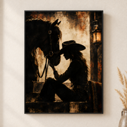Framed canvas wall art depicting a cowgirl in a wide-brimmed hat resting her forehead against a dark horse on a neutral wall