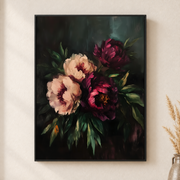 Framed burgundy and blush peony canvas wall art with dark green foliage on a light wall