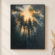 Framed canvas wall art depicting warm rays of sun filtering through tall evergreen branches in a misty forest on a neutral wall