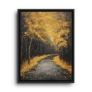 Black floating frame canvas depicting a winding woodland road covered in golden leaves beneath tall autumn trees