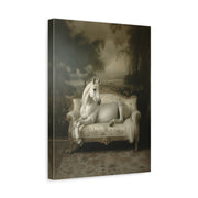 Unframed gallery wrapped canvas depicting a white horse standing beside a pale antique sofa in a moody interior